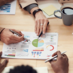 HR professional analyzing recruitment metrics on laptop with charts and graphs