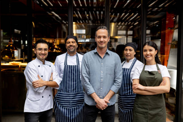 Owner with his staff at a restaurant.