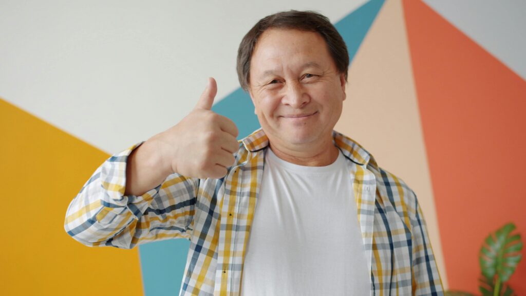 Satisfied customer giving a thumbs up after sharing positive video feedback
