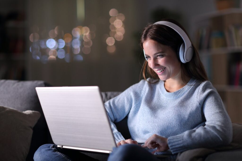 Woman engaging with a personalized video outreach message on laptop